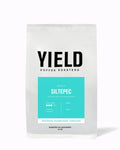 Yield Coffee Roasters coffee package with teal label on a white background